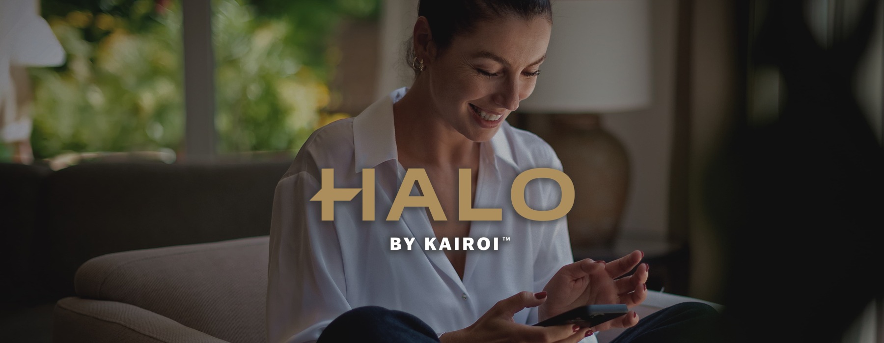 a woman smiling and interacting with her device